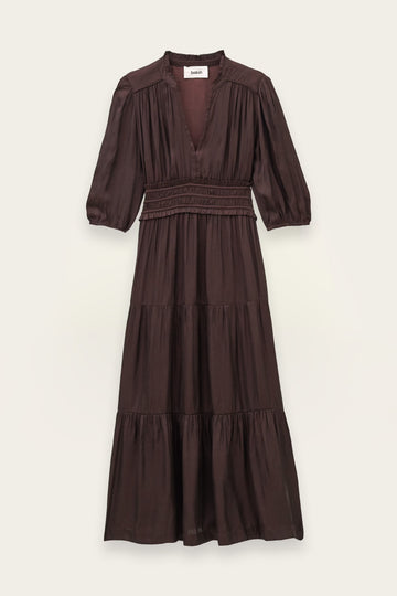 A dark brown tiered midi dress with three-quarter puff sleeves, a smocked waist, and a deep V-neckline, shown flat against a light beige background.