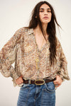 woman wearing paisley blue and brown shirt and jeans on white background