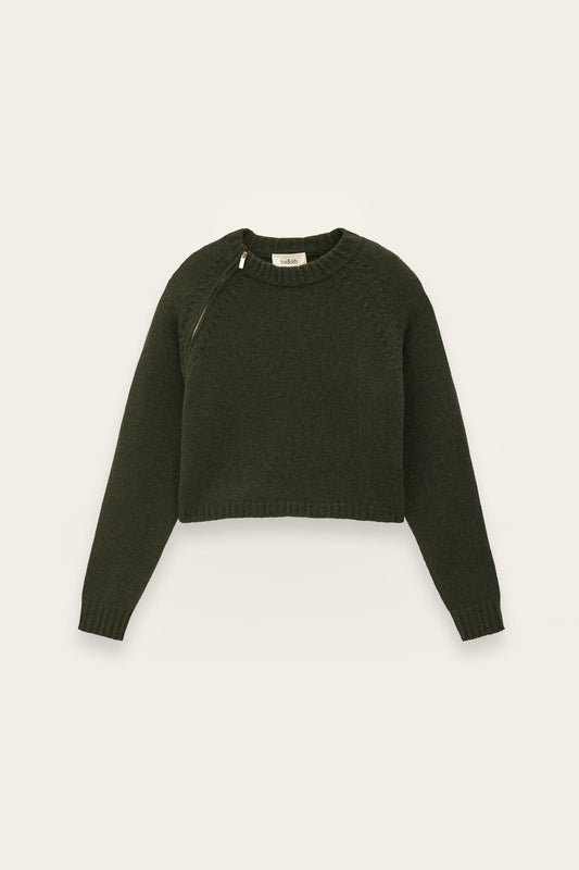 An olive green cropped knit sweater with long sleeves and diagonal shoulder seams, displayed flat against a light off-white background.