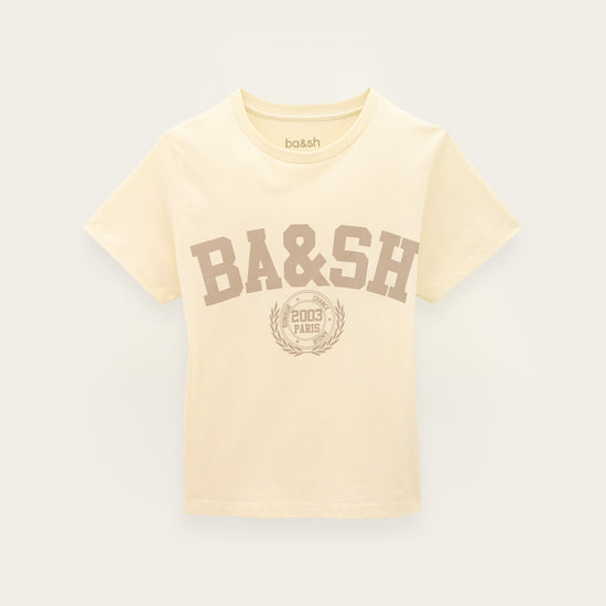 A cream-colored short-sleeve t-shirt with a brown 'BA&SH' collegiate-style graphic on the front, displayed against a light off-white background.