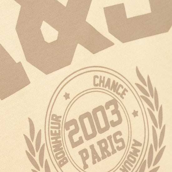 Beige textured surface with embossed or printed taupe-brown typography, including large stylized numbers at the top and a circular emblem reading '2003 PARIS' with surrounding text and laurel branches.