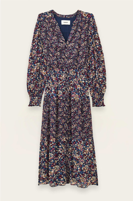 A long-sleeve midi dress with a dense multicolor floral print on a dark navy base, featuring a V-neckline and gathered waist, shown flat against a light cream background.