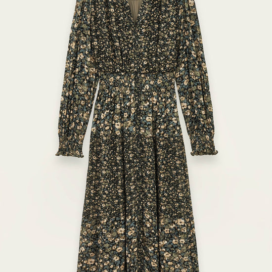 A long-sleeve midi dress with a dark green base and a dense beige and light green floral print, featuring a V-neckline and a gathered waist, shown against a light off-white background.