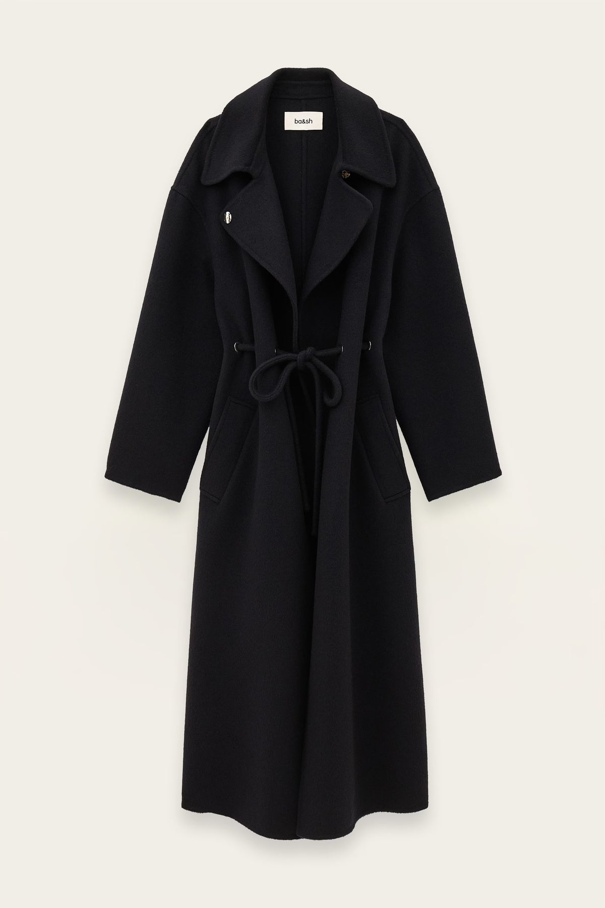 A long dark blue wool-blend coat with a tie belt, wide lapels, and front patch pockets, shown flat against a light off-white background.