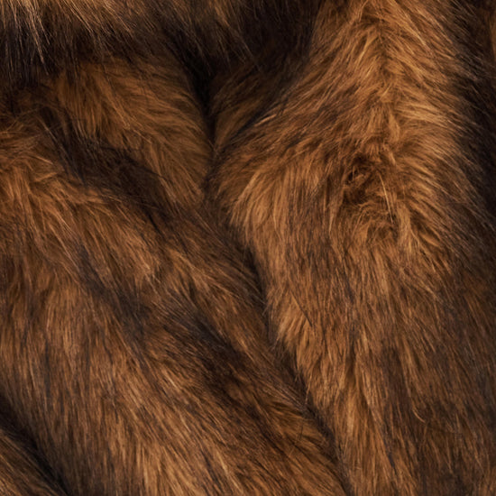 A close-up of rich brown faux fur fabric with soft, shaggy texture and darker shadowed areas.