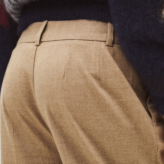 Close up of the rear of a pair of beige trousers