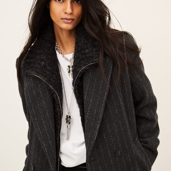 model wearing a grey pinstripe wool coat  and white t shirt 