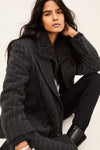 model wearing a grey pinstripe wool coat  and white t shirt side view