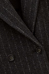 Close-up of a dark charcoal gray pinstripe wool-blend jacket fabric, showing the fine vertical stripe pattern and dark buttons.