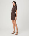 Woman wearing a brown dress with a white background