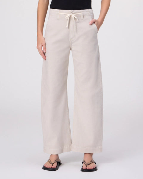 Beige wide-leg pants worn by a person on a white background