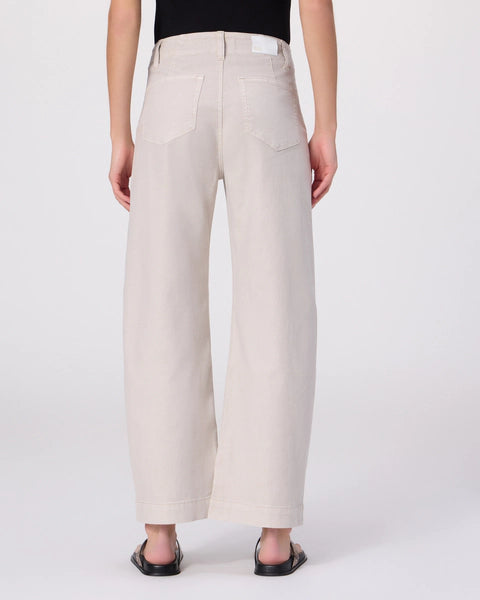 Person wearing beige pants on a white background