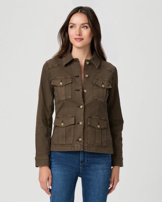 A woman modeling a dark brown utility jacket with four front flap pockets and button closures, paired with blue jeans, against a light gray studio background.