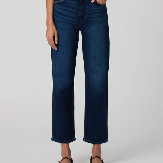 Person wearing blue jeans on a white background