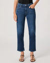 Person wearing blue jeans by paige on a plain background
