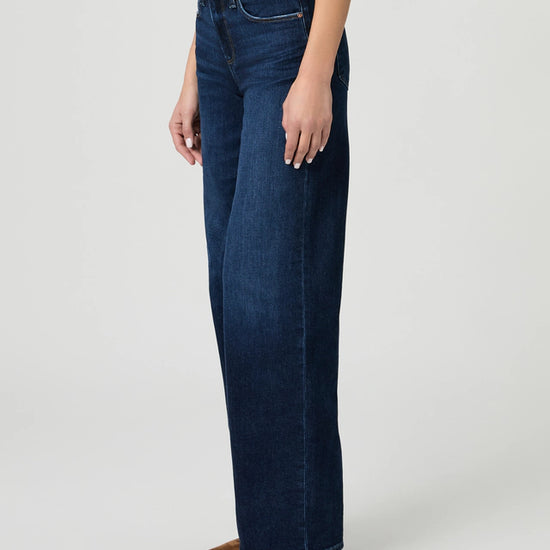 Person wearing blue jeans on a white background from paige