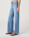 Woman wearing light blue jeans from Paige on a white background side view