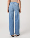Woman wearing light blue jeans from Paige on a white background rear view