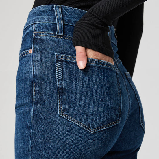 close up pocket detail of blue straight leg jeans