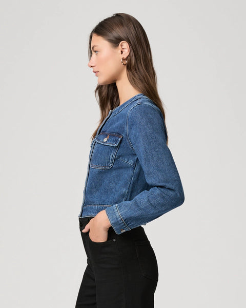 round neck dark blue denim jacket with silver buttons, 2 flap buttoned pockets and cropped fit side view