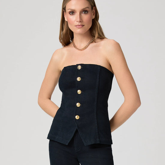 Woman wearing a strapless denim top with gold buttons from Paige