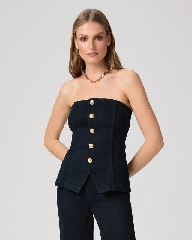 Woman wearing a strapless denim top with gold buttons from Paige