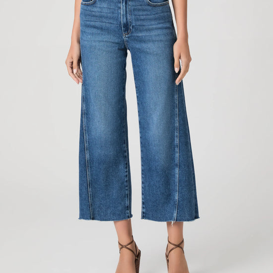 person wearing blue paige jeans on a white background 