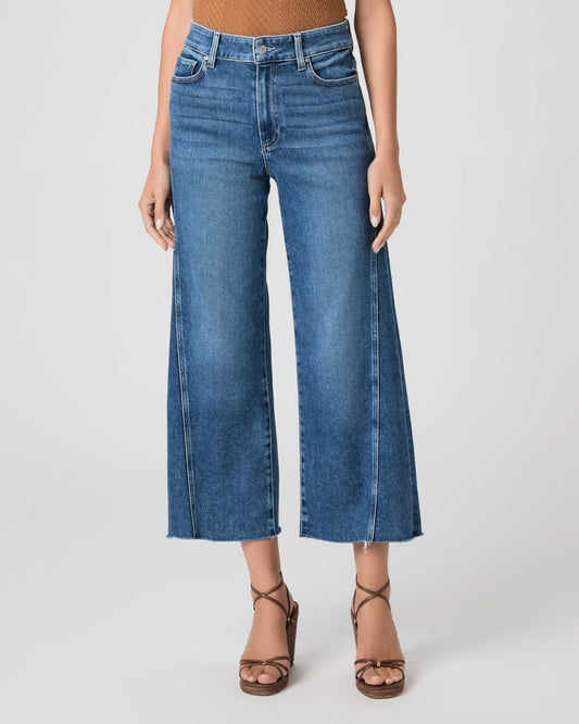 person wearing blue paige jeans on a white background 