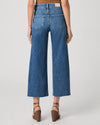 person wearing blue paige jeans on a white background rear view