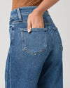 person wearing blue paige jeans on a white background close up 