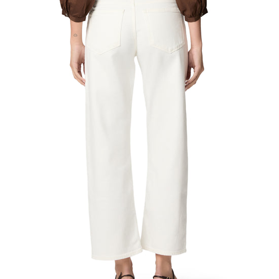 woman wearing white jeans on white background rear view