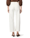 woman wearing white jeans on white background rear view