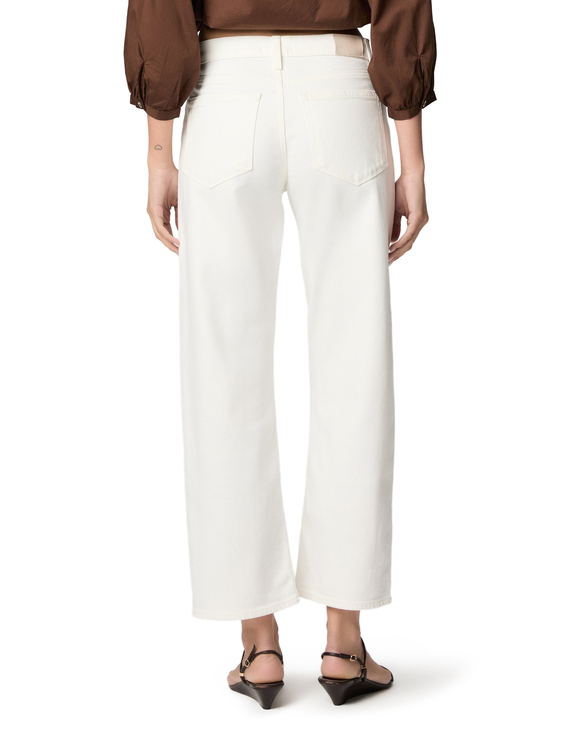 woman wearing white jeans on white background rear view