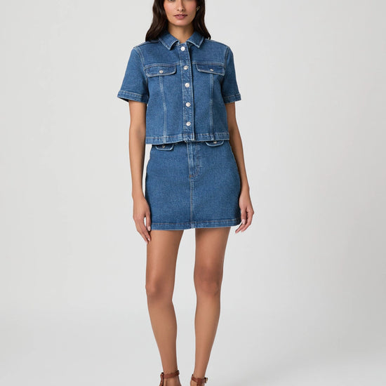 Woman wearing a denim outfit on a white background