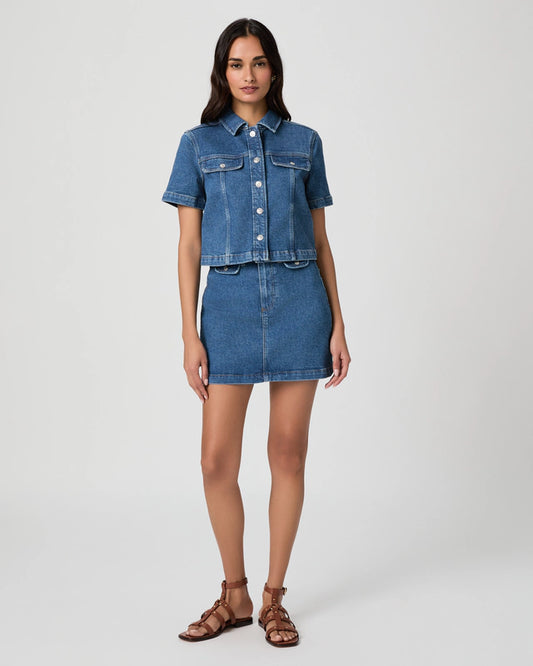 Woman wearing a denim outfit on a white background