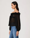Woman wearing a black off-shoulder top with floral details on a white background