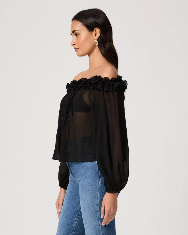 Woman wearing a black off-shoulder top with floral details on a white background