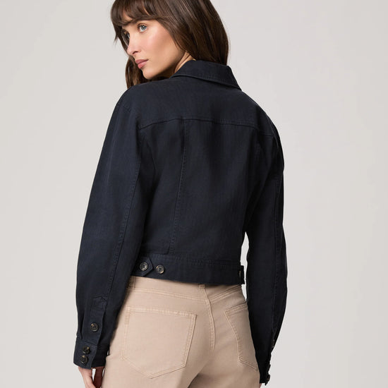 Rear view of navy blue casual jacket worn with beige trousers from Paige