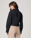 Rear view of navy blue casual jacket worn with beige trousers from Paige