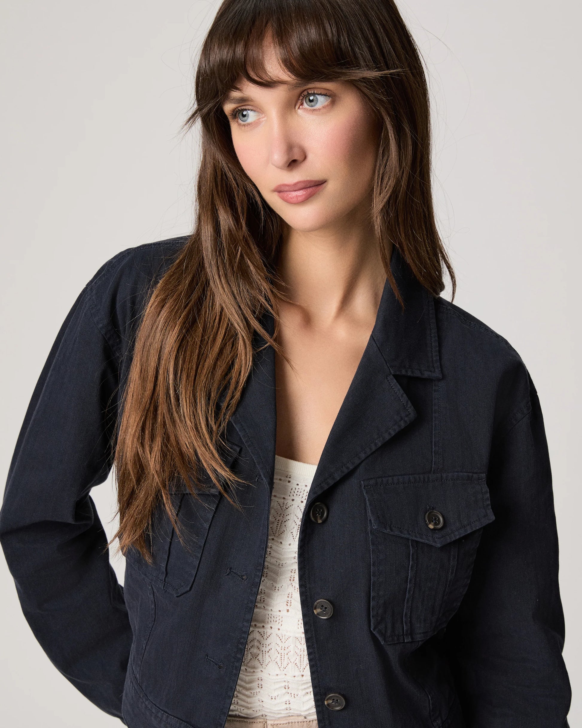 navy blue casual jacket worn with white vest tee from Paige