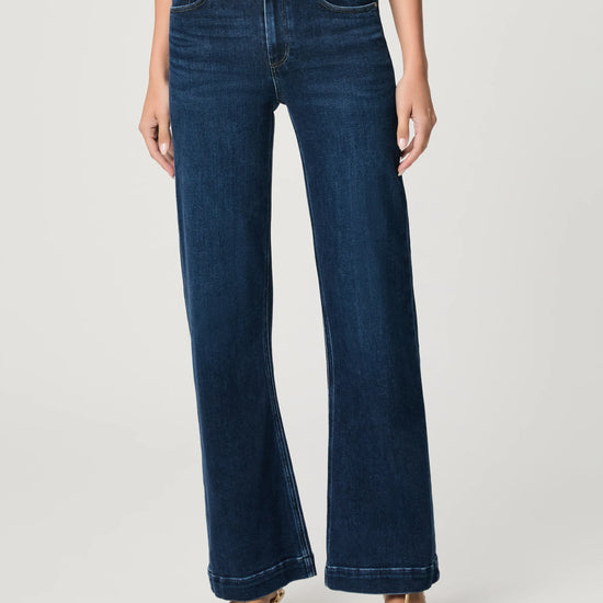 Blue jeans worn by a person on a white background