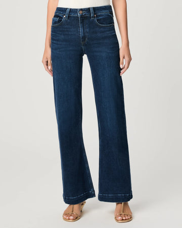 Blue jeans worn by a person on a white background