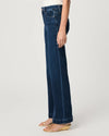 Person wearing dark blue jeans on a white background