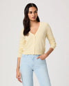 woman wearing a yellow cardigan by paige.