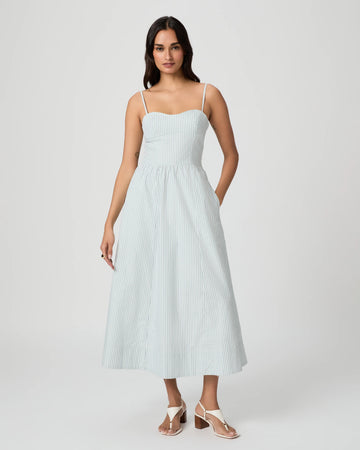 Woman wearing a light blue striped dress on a white background from Paige
