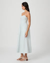 Woman wearing a light blue dress on a white background from Paige