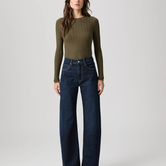 dark blue barrel leg jeans from paige model shot