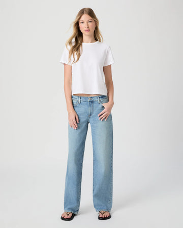 Woman wearing a white t-shirt and light blue jeans on a white background from Paige