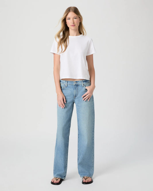 Woman wearing a white t-shirt and light blue jeans on a white background from Paige