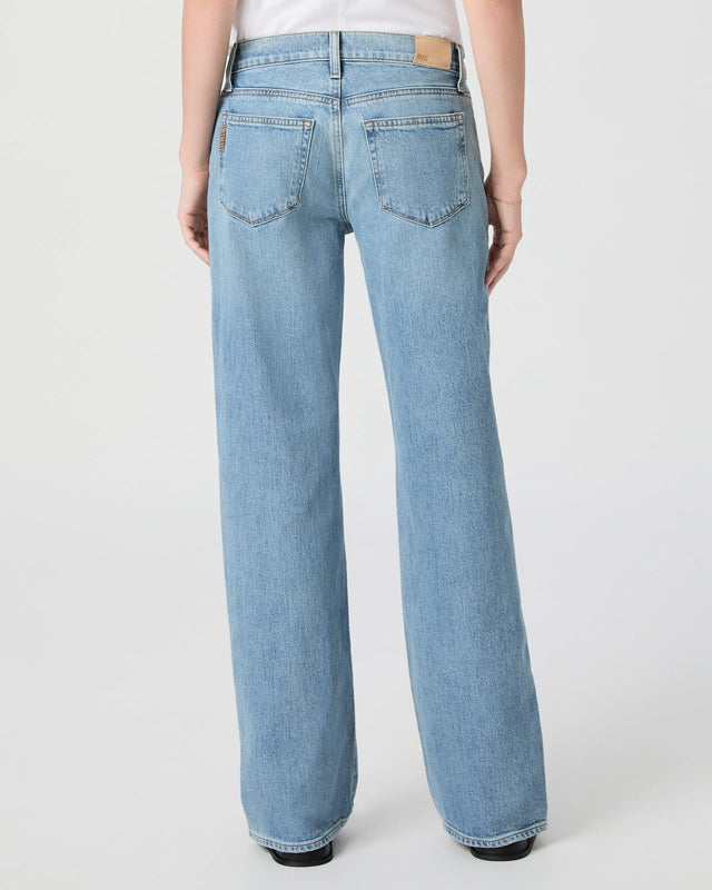 Light blue jeans worn by a person on a white background from paige